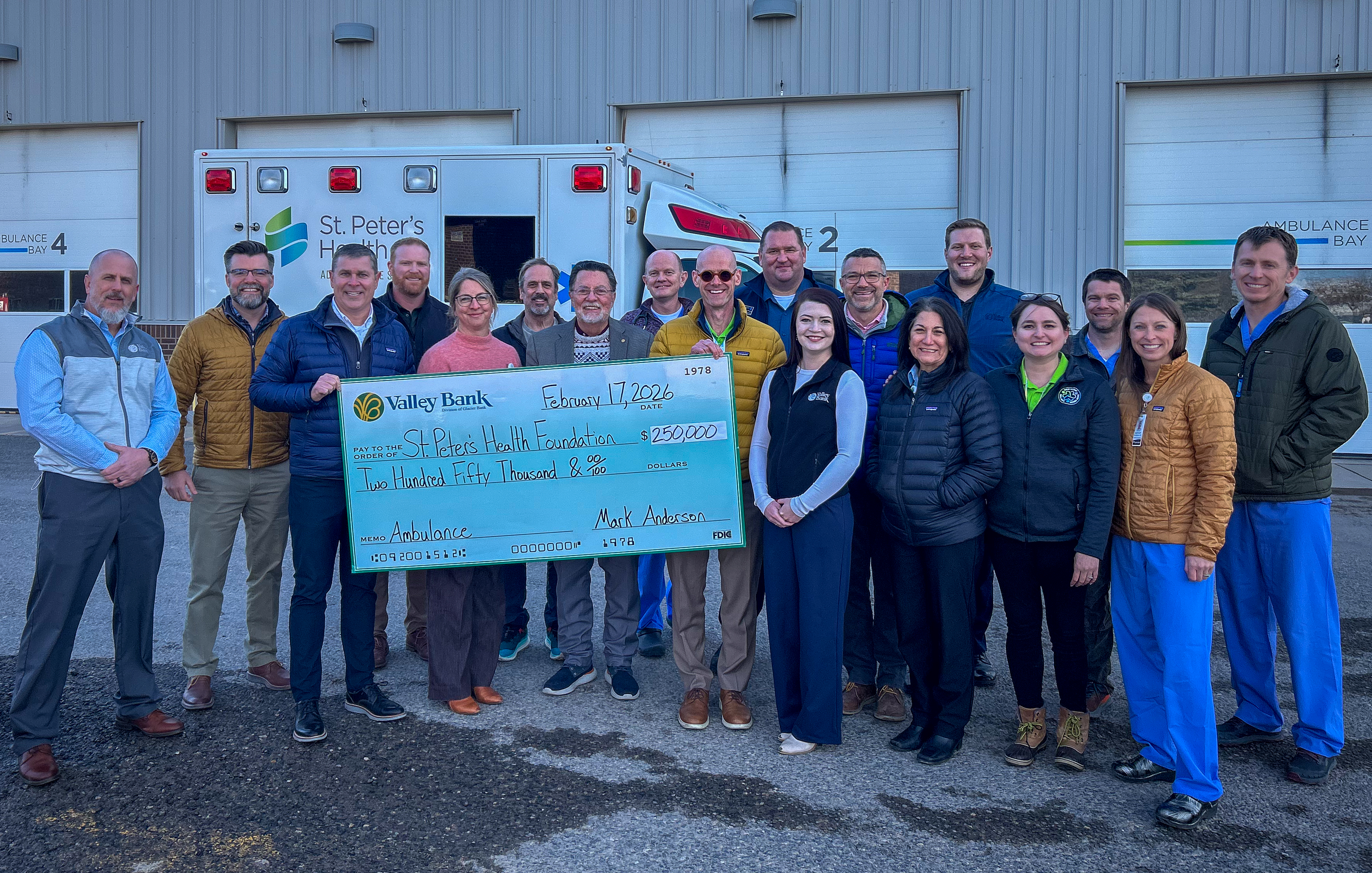 Representatives from Valley Bank and St. Peter's Health pose with a giant check commemorating the donation.