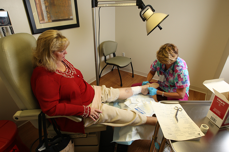 nurse with patient foot injury