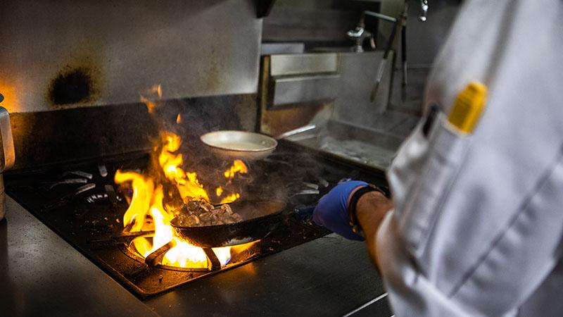 chef with flame on stove