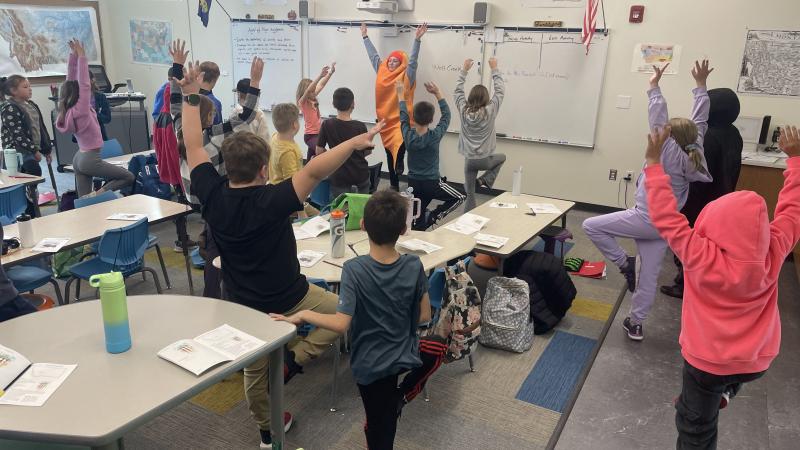 students doing carrot yoga in classroom