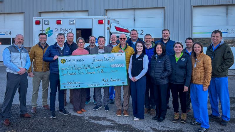 Representatives from Valley Bank and St. Peter's Health pose with a giant check commemorating the donation.